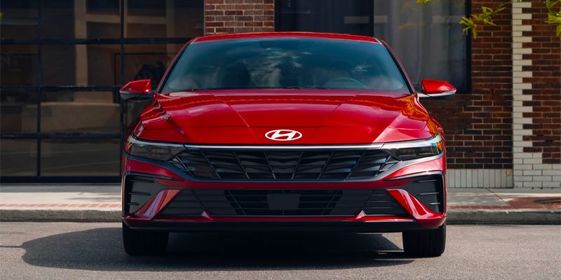 Front view of a red Hyundai Elantra parked on a city street