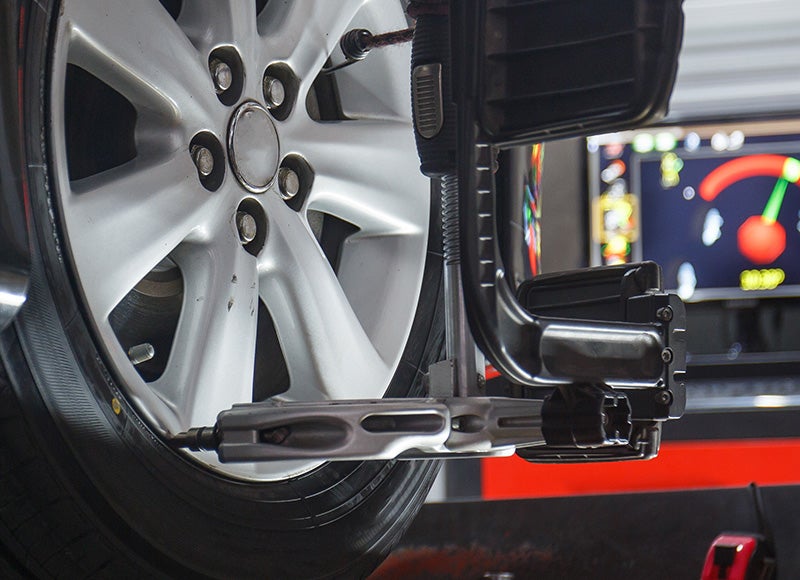 car tire alignment tool attached to tire