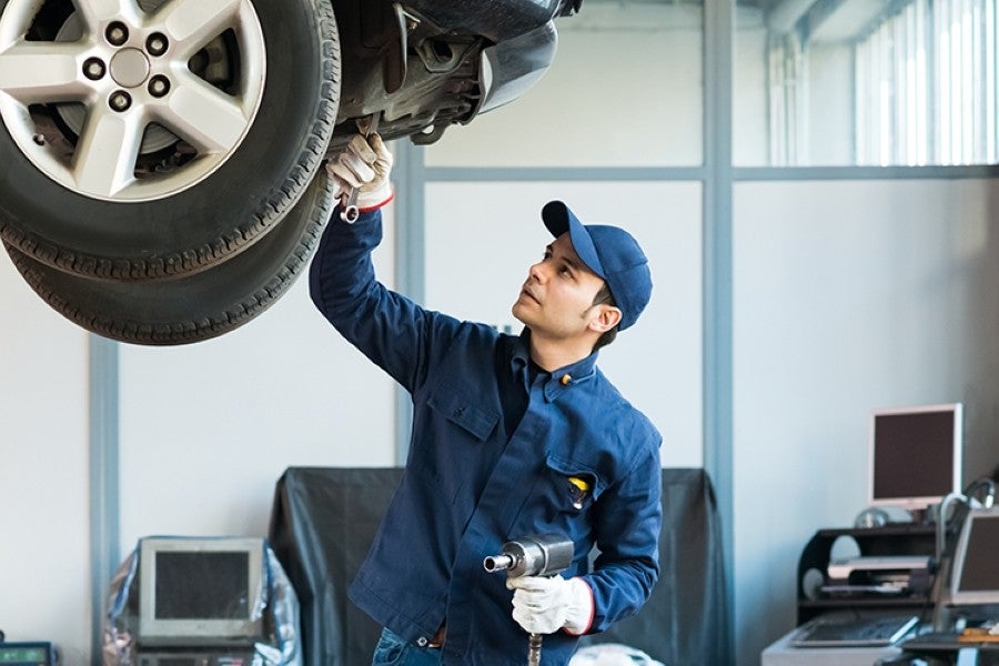 worker having an inspection of car tire